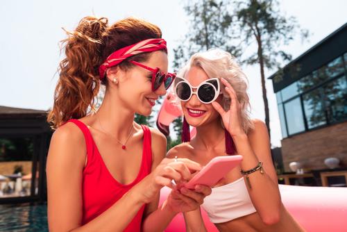 Two girls wearing sunglasses