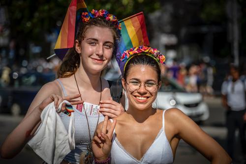 Two girls with rainbow flags