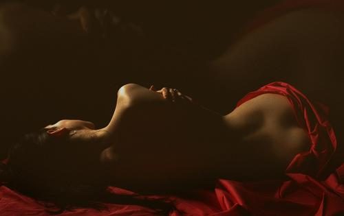 Woman on a red bed