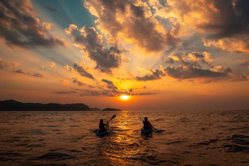 Couple kayaking at sunset