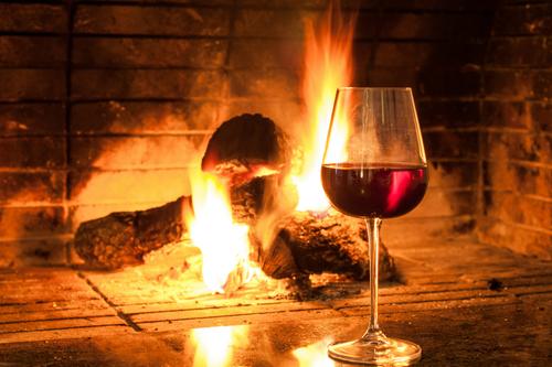 Glass of wine by the fireplace