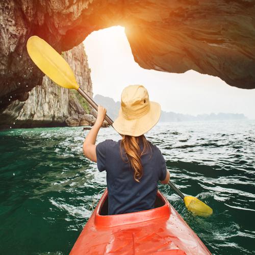 Canoeing through a cave in Halong Bay