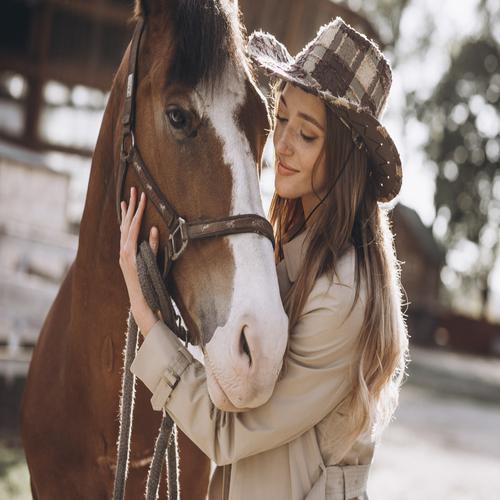 Young happy woman with horse