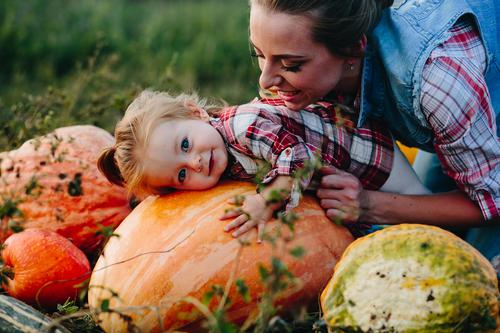 Mother and Daughter picking pumpkins
