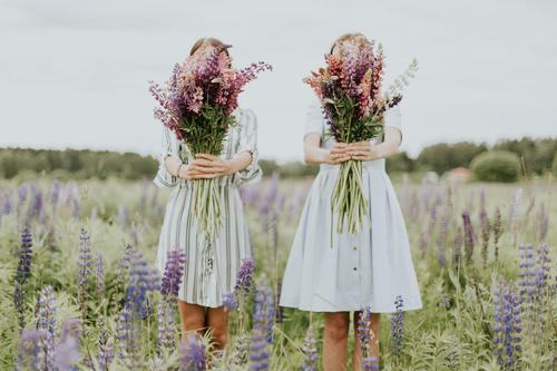 Two girls catching flowers